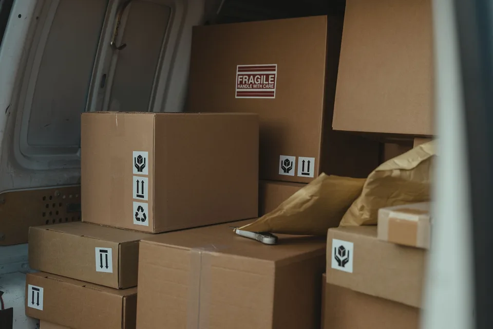 Carefully packed cardboard boxes arranged inside a cargo van